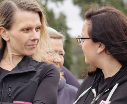 Group of four people in outdoor setting wearing winter clothing and jackets