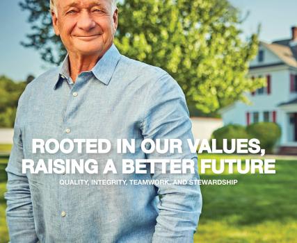 Older man in light blue shirt standing outdoors with house and trees in background, text reads "Rooted in our values, raising a better future"