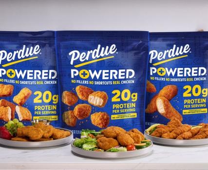 Three Perdue Powered chicken product packages with orange packaging and visible nutritional information displayed side by side.
