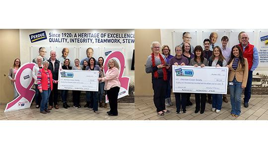 Two groups of Perdue employees holding large ceremonial checks at a company facility.