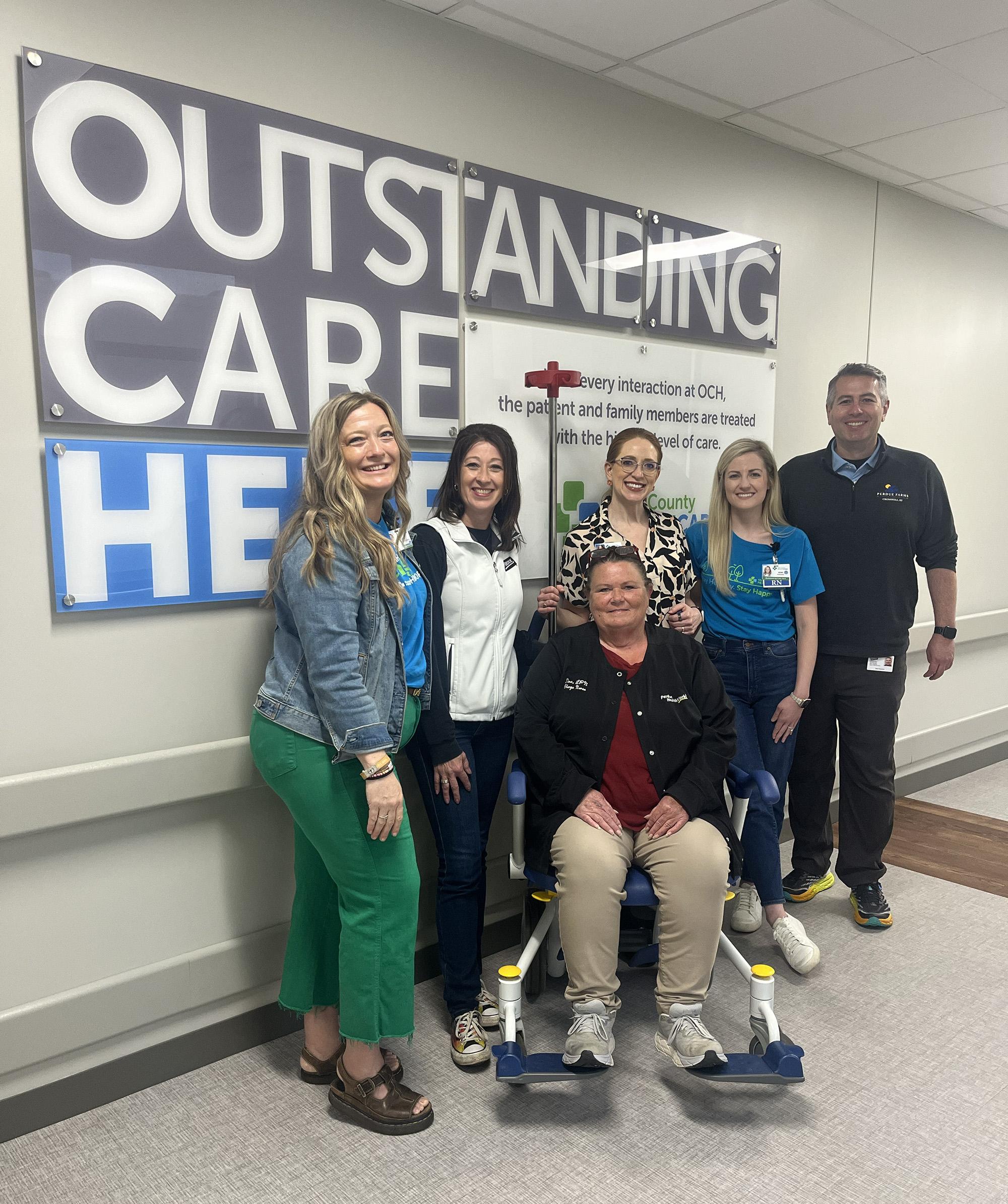 From left to right are Shelly Casteel, grant specialist for Ohio County Healthcare (OCH), Erin Groves, Perdue administrative assistant, Shelly Shouse CEO of OCH, Jamie Pharis, emergency room director, Allen Pavlovic, Perdue director of operations, and in wheelchair Tina Lamar, LPN charge nurse.