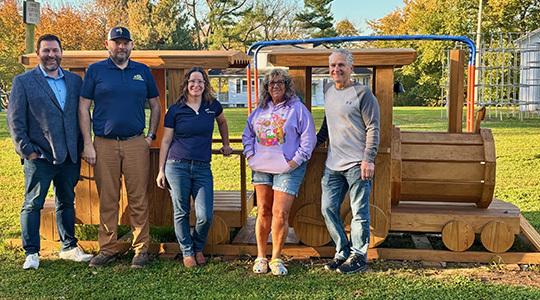 The Perdue Foundation funded a new wooden train for the Arch Street Playground in Bainbridge, Pa. From left to right are Perdue AgriBusiness associates John O&rsquo;Donnell, Kevin Woleab and Rebecca Day, and Conoy Township Supervisors Gina Mariani and Douglas Hawthorne.