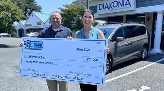 Kim Nechay, executive director of the Perdue Foundation, presents a $20,000 grant to Ken Argot, Diakonia executive director, to help fund purchase of a new van.