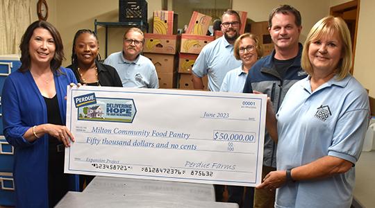 Kim Nechay, left, executive director of the Perdue Foundation, presents a $50,000 grant to the Milton Community Food Pantry in Delaware. From left to right are Nechay, Aleeshia Belle, Perdue HR manager in Georgetown, Lawrence Bivens, Pantry Board member, Tompall Toone, secretary, Bobbie Hemmings, treasurer, Mark Shipley, Perdue plant manager, and Donna Murawski, Board president.