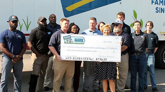 America&rsquo;s Second Harvest of Coastal Georgia Rick Corona, facility Manager for Perdue, presents a $50,000 check to Mary Jane Crouch surrounded by associates from the company&rsquo;s Southeast Distribution Center in Rincon.
