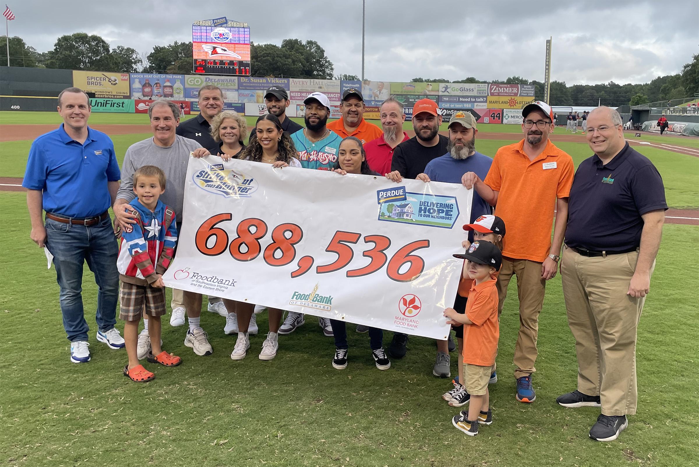 Representatives from Perdue Farms, the Delmarva Shorebirds, the Maryland Food Bank, the Food Bank of Delaware, the Foodbank of Southeastern Virginia and the Eastern Shore and Care First celebrate a record year for the annual Perdue Strike Out Hunger Challenge on Delmarva which generated more than 688,000 meal equivalents across the region.