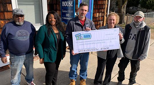 Matt Hearn, center, Perdue Director of Operations in Georgetown, Del., presents a $20,000 Perdue Foundation grant to Maria Evans, executive director of Sussex Community Crisis Housing Services. From left are Daniel Bell, maintenance person, Aleeshia Webster, Perdue HR manager, Hearn, Evans and client Jeff Botts.